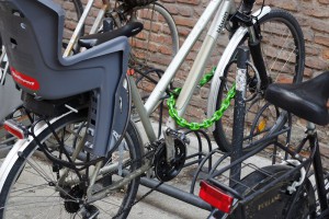 A chain with a padlock locks together the front wheel and the frame to a fixed point and a large steel cable locks the rear wheel.